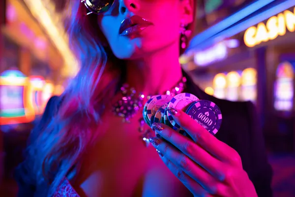 A confident dealer surrounded by casino chips inviting players to access their TALABAT account, reflecting quick and easy login options.